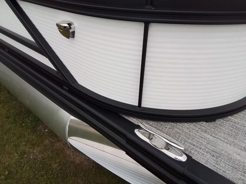 Slide: The Image of Close-up of a Bennington 23SSRSF pontoon boat with white panels and metal fittings. - 26