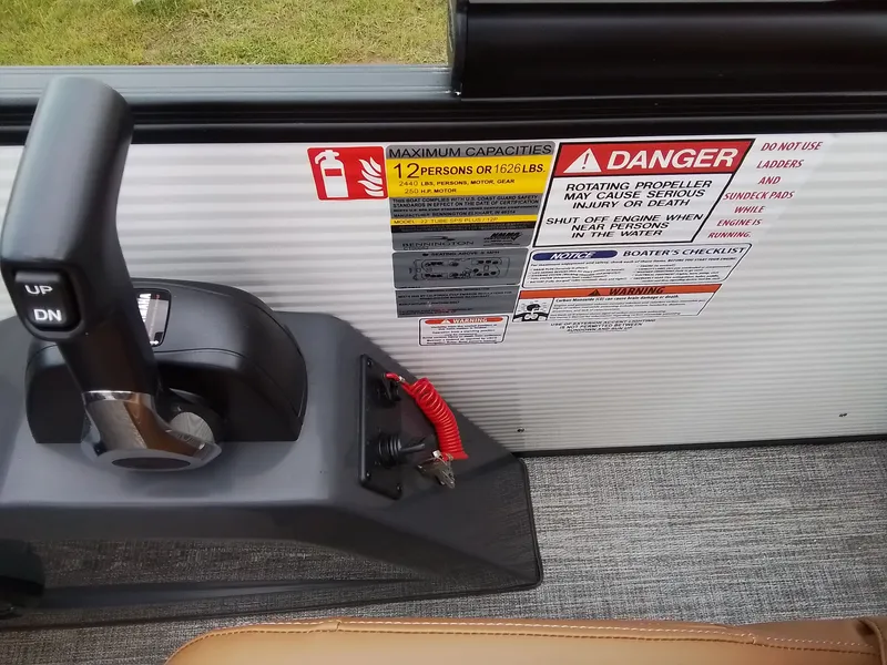 Slide: The Image of Close-up of a boat control area with warning labels and a lever. - 27