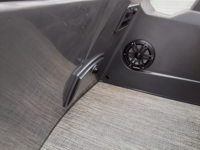 Slide: The Image of Close-up of a speaker in a boat with gray carpet flooring. - 29