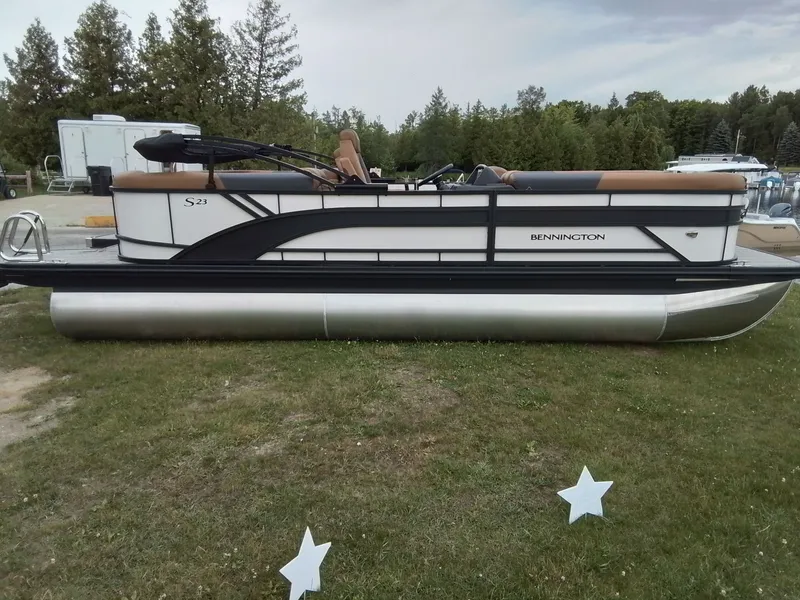 Slide: The Image of Bennington 23SSRSF pontoon boat on grass with trees in the background. - 3
