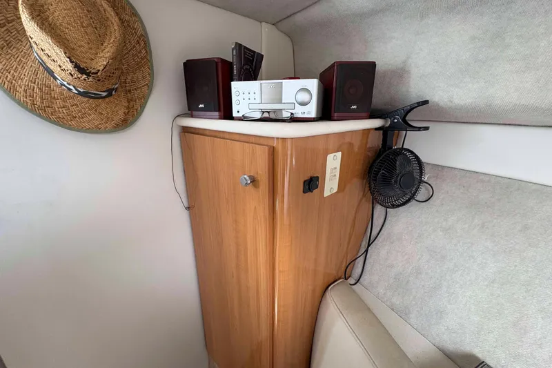 Slide: The Image of 2001 Bayliner 3258 Command Bridge interior with stereo, speakers, fan, and straw hat. - 23