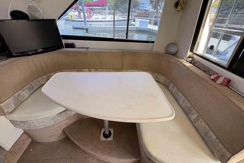 Slide: The Image of Interior of 2001 Bayliner 3258 Command Bridge with cozy seating and table. - 20