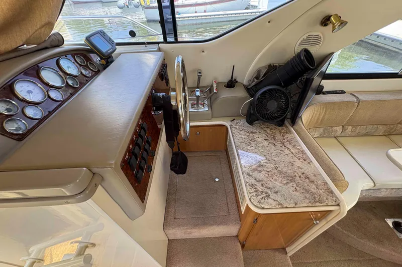 Slide: The Image of 2001 Bayliner 3258 Command Bridge helm with gauges, steering wheel, and marble countertop. - 18