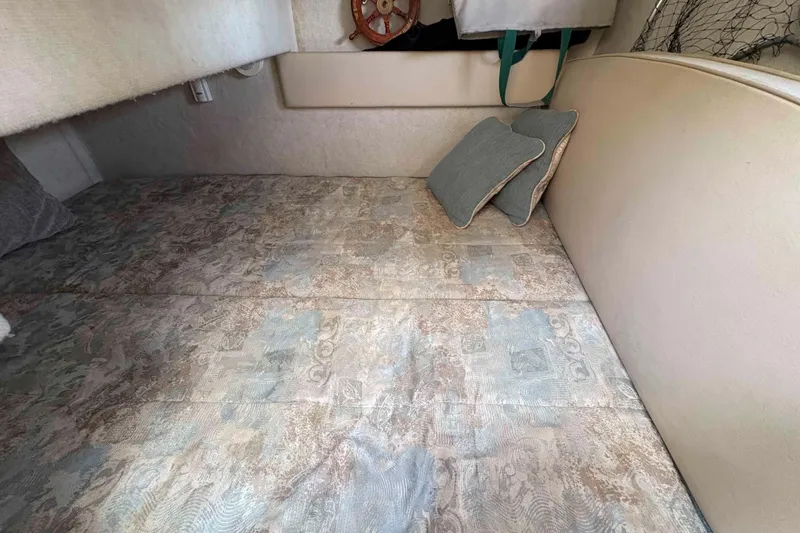 Slide: The Image of Interior cabin of 2001 Bayliner 3258 Command Bridge with patterned bedding and cushions. - 21