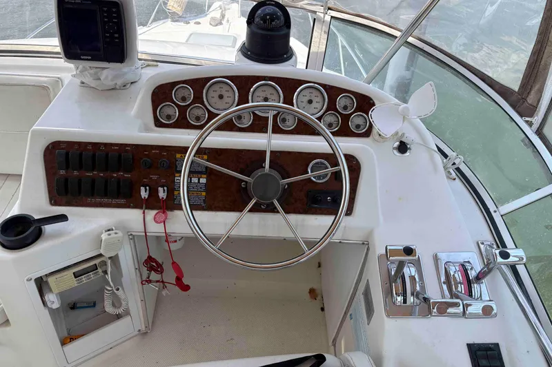 Slide: The Image of Cockpit of 2001 Bayliner 3258 Command Bridge with steering wheel and control panel. - 2