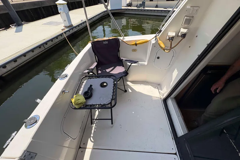 Slide: The Image of 2001 Bayliner 3258 Command Bridge cockpit with chair and table at marina. - 16