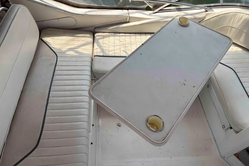 Slide: The Image of 2001 Bayliner 3258 Command Bridge interior with white seating and table. - 3