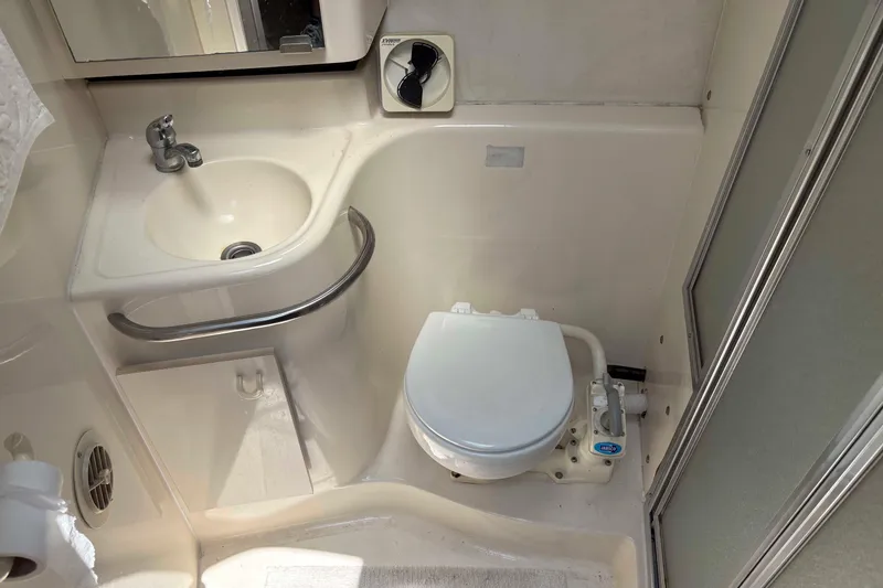 Slide: The Image of 2001 Bayliner 3258 Command Bridge bathroom with sink, toilet, and shower. - 27