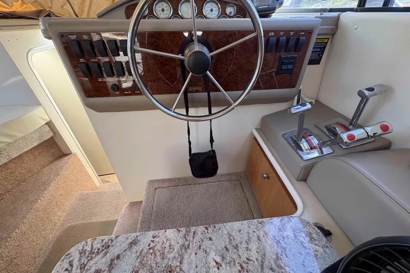 Slide: The Image of Interior helm of 2001 Bayliner 3258 Command Bridge with steering wheel and control panel. - 26