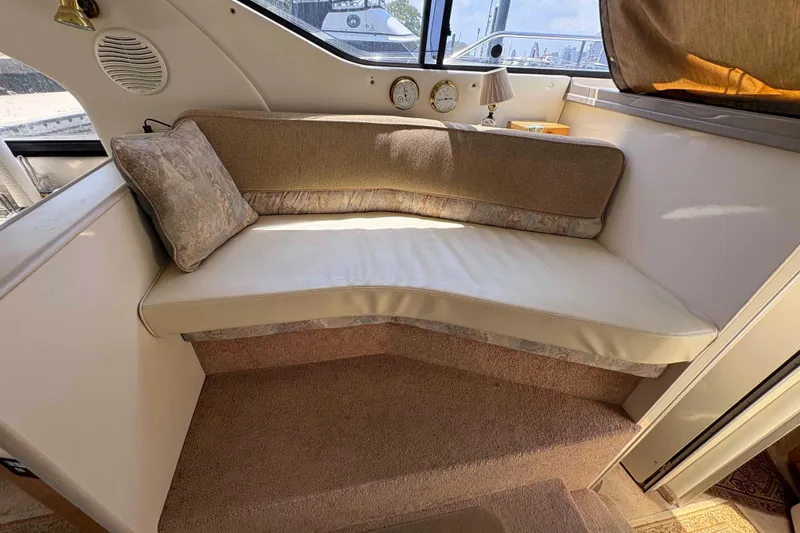 Slide: The Image of Interior seating area of 2001 Bayliner 3258 Command Bridge with cushions and nautical decor. - 19