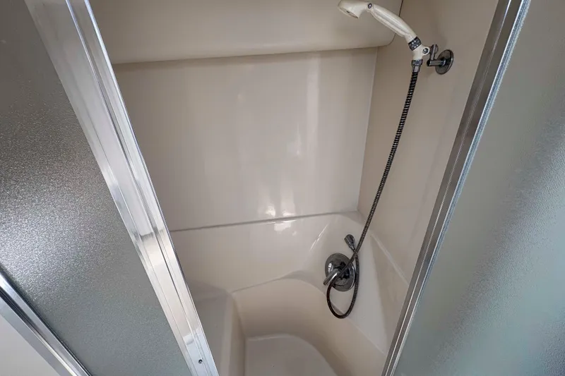 Slide: The Image of Shower area in 2001 Bayliner 3258 Command Bridge boat, featuring handheld showerhead. - 29