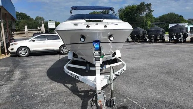 Slide: The Image of A 2005 Regal 2400 LSR boat on a trailer in a parking lot. - 8
