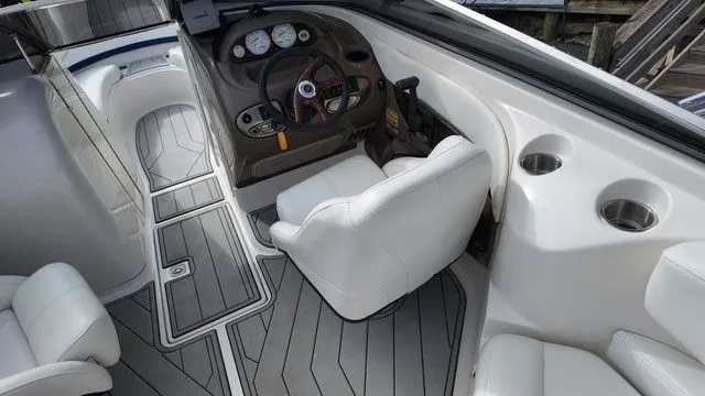 Slide: The Image of The image shows the cockpit of a 2005 Regal 2400 LSR boat with white seats and gray flooring. - 21