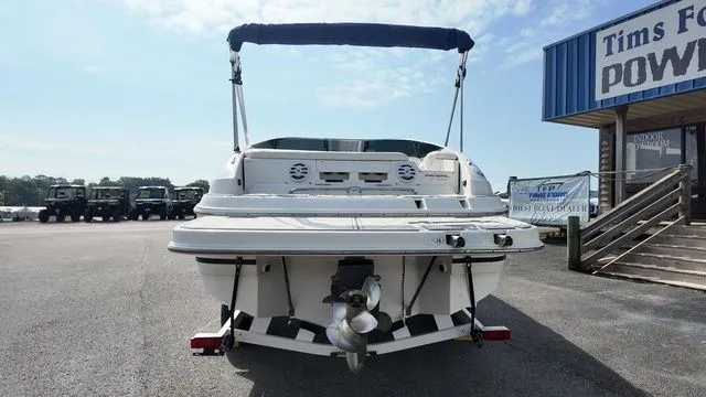 Slide: The Image of The image shows a 2005 Regal 2400 LSR boat on a trailer in front of a store. - 3