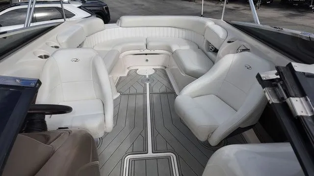 Slide: The Image of The image shows the cockpit of a 2005 Regal 2400 LSR boat with white seating. - 23