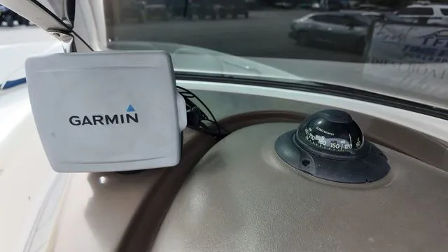 Slide: The Image of Close-up of a Garmin device and compass on a Regal 2400 LSR boat. - 25