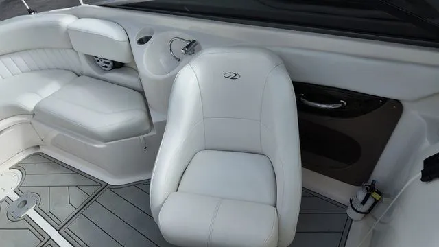 Slide: The Image of Interior of a 2005 Regal 2400 LSR boat with white leather seating. - 18