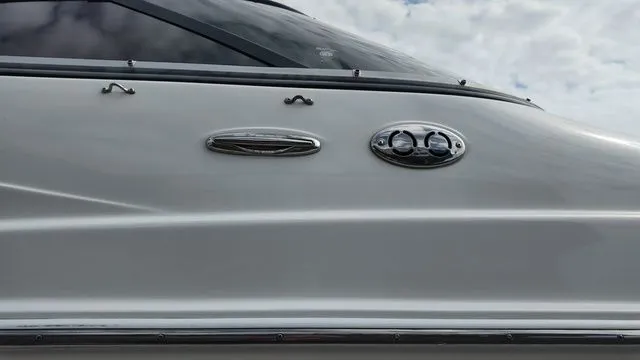 Slide: The Image of Close-up of a 2005 Regal 2400 LSR boat's side with shiny details. - 27