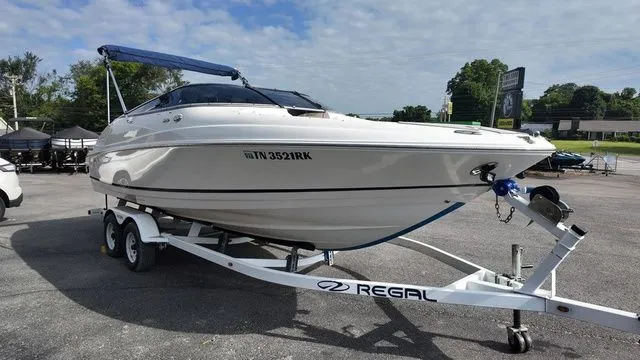 Slide: The Image of 2005 Regal 2400 LSR on a trailer, featuring a blue sunshade. - 7