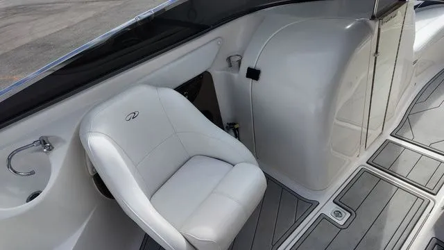 Slide: The Image of A white seat in a boat with gray flooring and a curved wall. - 17
