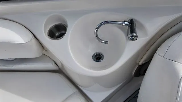 Slide: The Image of Close-up of a white boat seat and built-in sink with a faucet. - 19