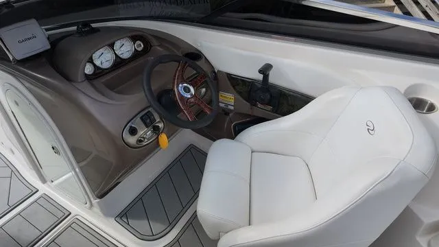 Slide: The Image of The image shows the cockpit of a 2005 Regal 2400 LSR boat with a white seat. - 15