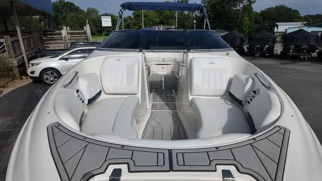 Slide: The Image of The image shows the cockpit of a 2005 Regal 2400 LSR boat with white seating. - 10