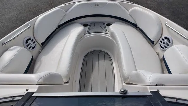 Slide: The Image of The image shows the bow area of a 2005 Regal 2400 LSR boat with white upholstery. - 14