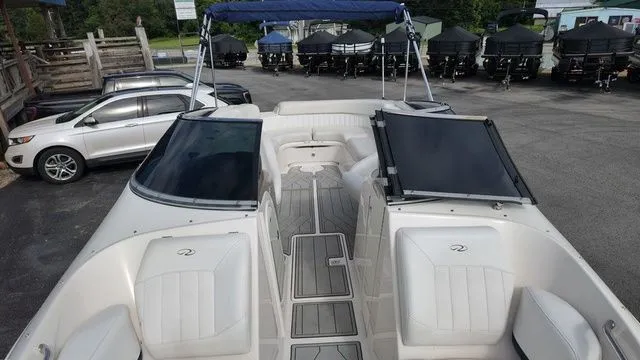 Slide: The Image of The image shows a 2005 Regal 2400 LSR boat with an open deck and blue sunshade. - 22