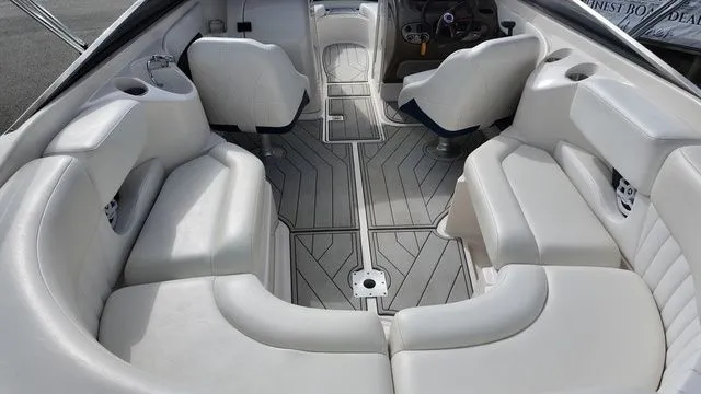 Slide: The Image of The image shows the interior of a 2005 Regal 2400 LSR boat with white seating. - 13