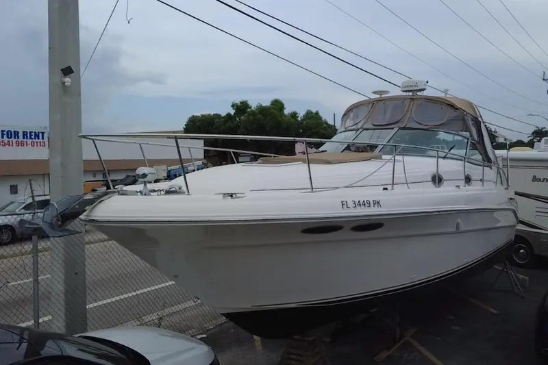 Slide: The Image of 2002 Sea Ray 340 Sundancer boat docked in a marina, side view. - 10
