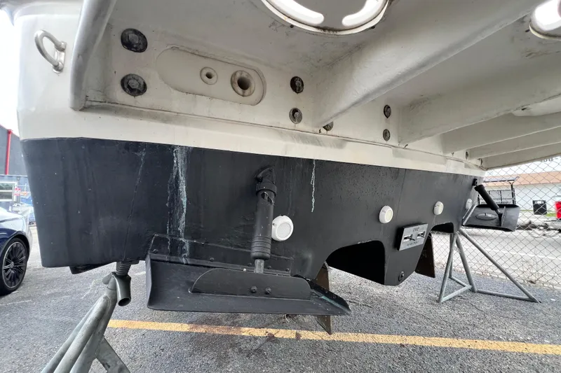 Slide: The Image of 2002 Sea Ray 340 Sundancer boat hull and stern view in a marina setting. - 14
