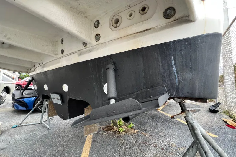 Slide: The Image of 2002 Sea Ray 340 Sundancer boat hull on stands, showing underside details. - 19