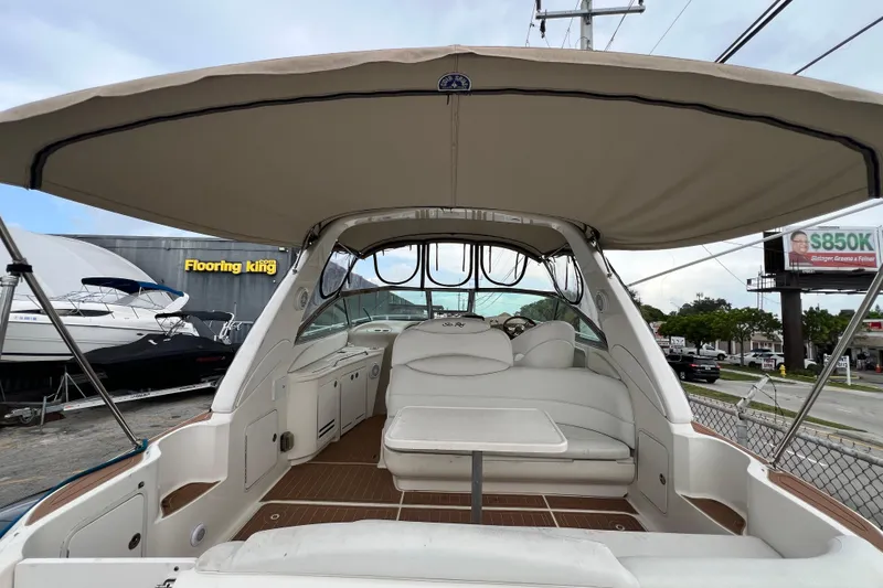 Slide: The Image of 2002 Sea Ray 340 Sundancer boat interior with canopy and seating area. - 24