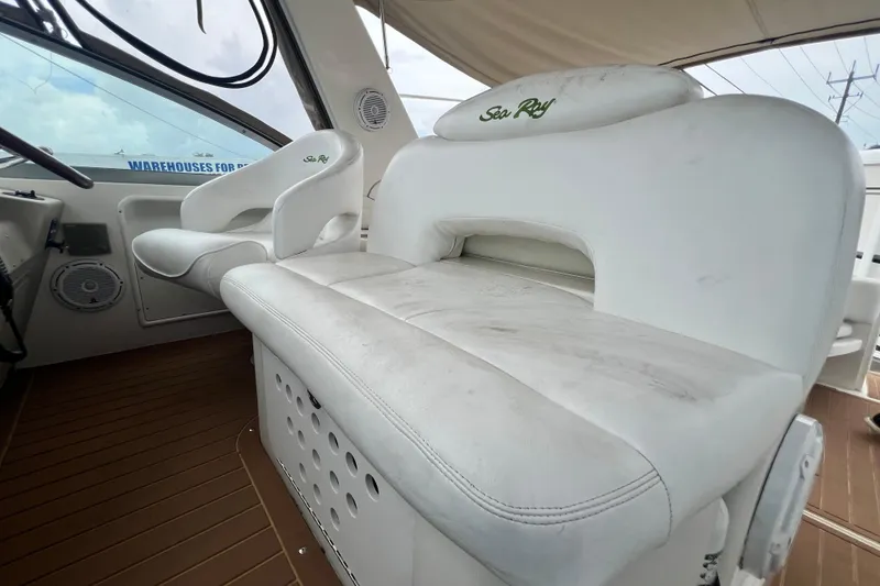 Slide: The Image of Interior seating of 2002 Sea Ray 340 Sundancer boat, featuring white cushioned seats. - 27