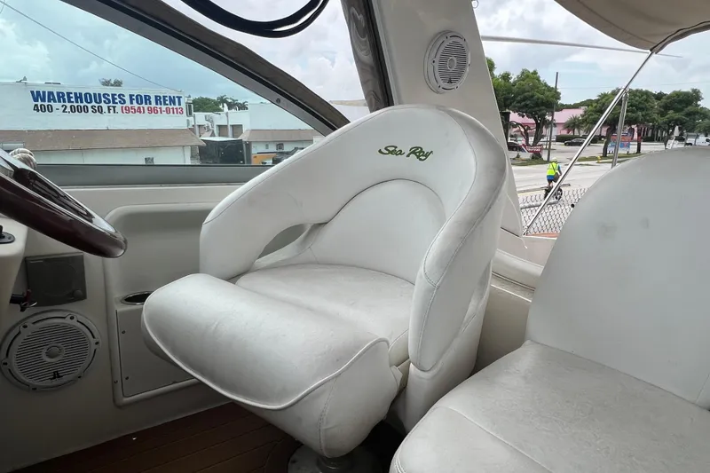Slide: The Image of Captain's seat on 2002 Sea Ray 340 Sundancer boat, with steering wheel and speaker. - 28