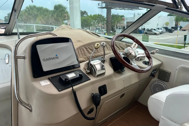 Slide: The Image of Helm of 2002 Sea Ray 340 Sundancer with Garmin navigation system and wood-accented steering wheel. - 29