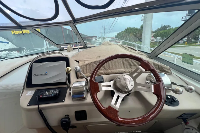 Slide: The Image of 2002 Sea Ray 340 Sundancer helm with Garmin navigation system and wooden steering wheel. - 30