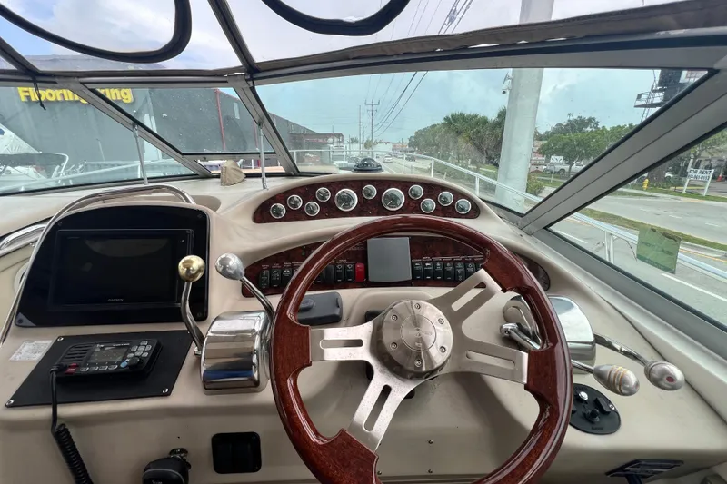 Slide: The Image of Cockpit view of 2002 Sea Ray 340 Sundancer with steering wheel and control panel. - 31