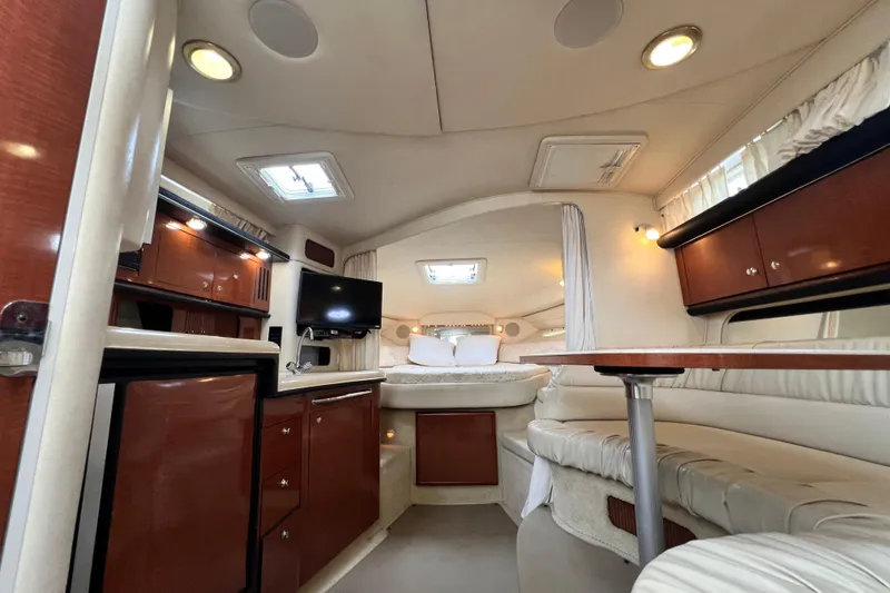 Slide: The Image of Interior of 2002 Sea Ray 340 Sundancer yacht with cozy seating and modern amenities. - 32