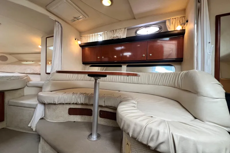 Slide: The Image of Interior of 2002 Sea Ray 340 Sundancer yacht with plush seating and wooden cabinetry. - 33