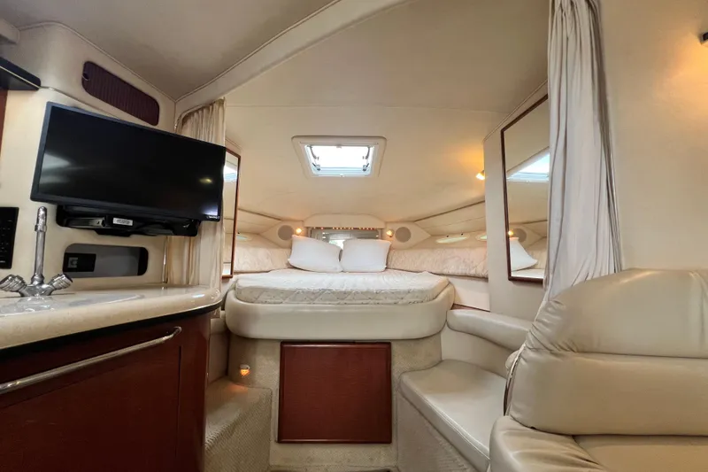 Slide: The Image of Interior of 2002 Sea Ray 340 Sundancer yacht with bed, TV, and seating area. - 35