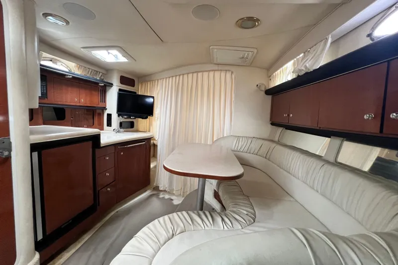 Slide: The Image of Interior of 2002 Sea Ray 340 Sundancer yacht with kitchenette, seating, and TV. - 41