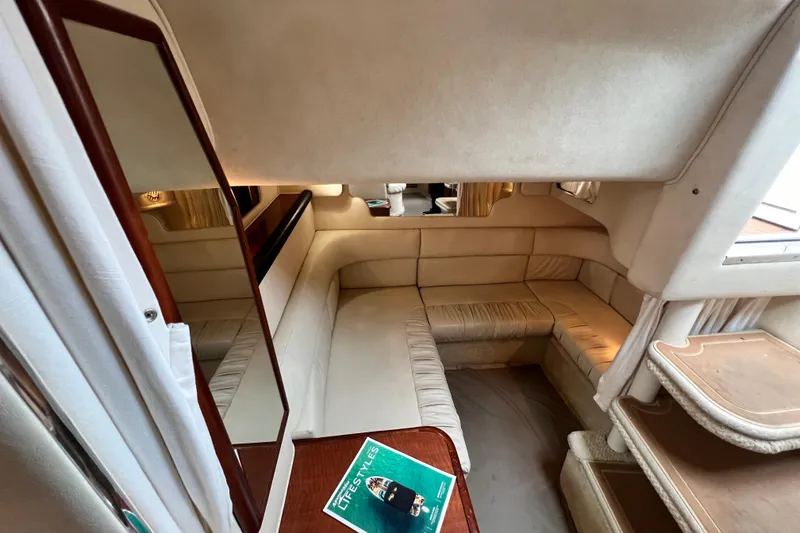 Slide: The Image of Interior of 2002 Sea Ray 340 Sundancer yacht with beige seating and wooden accents. - 42