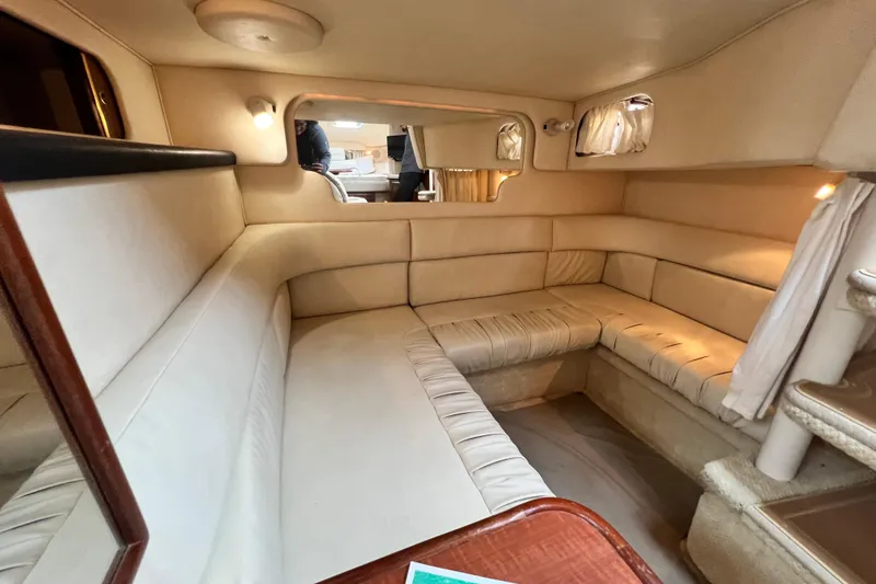 Slide: The Image of Interior of 2002 Sea Ray 340 Sundancer yacht with beige seating and cozy lighting. - 43