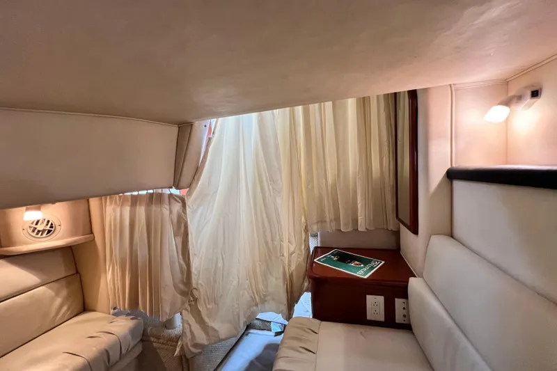 Slide: The Image of Interior cabin of 2002 Sea Ray 340 Sundancer with beige seating and curtains. - 46