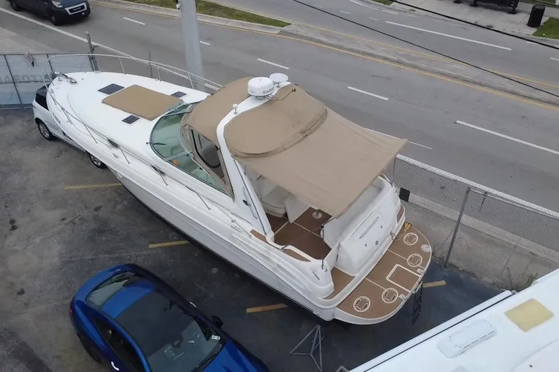 Slide: The Image of 2002 Sea Ray 340 Sundancer yacht parked near road, aerial view. - 5