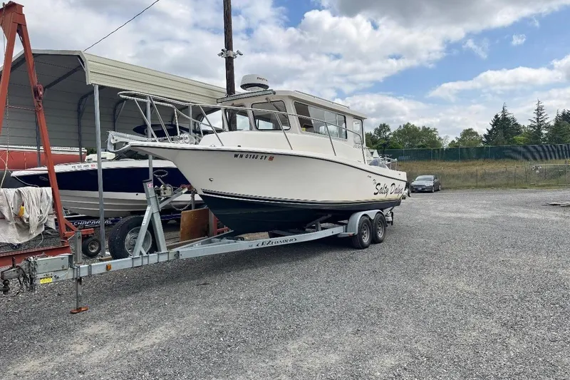 Slide: The Image of 2020 Defiance San Juan 250 boat on trailer in outdoor storage area. - 1