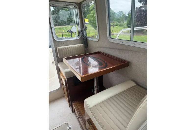 Slide: The Image of Interior of 2020 Defiance San Juan 250 boat with seating and wooden table. - 10