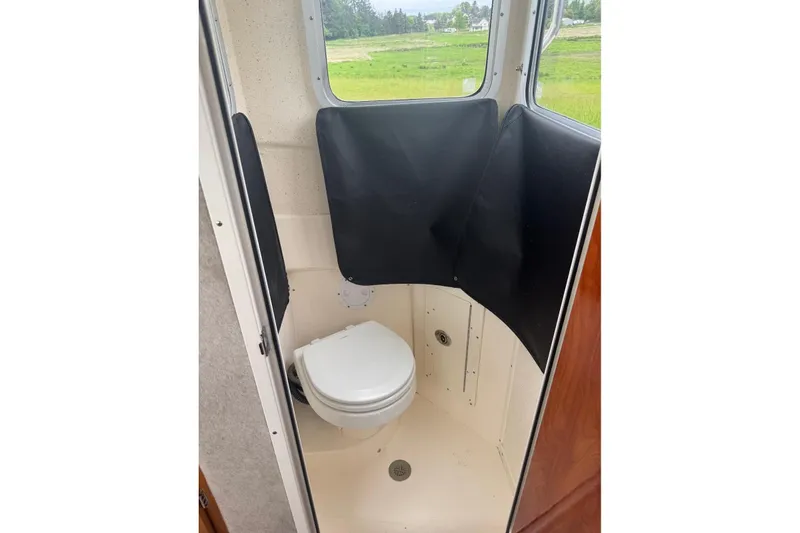 Slide: The Image of Compact bathroom in 2020 Defiance San Juan 250 boat with window view. - 18